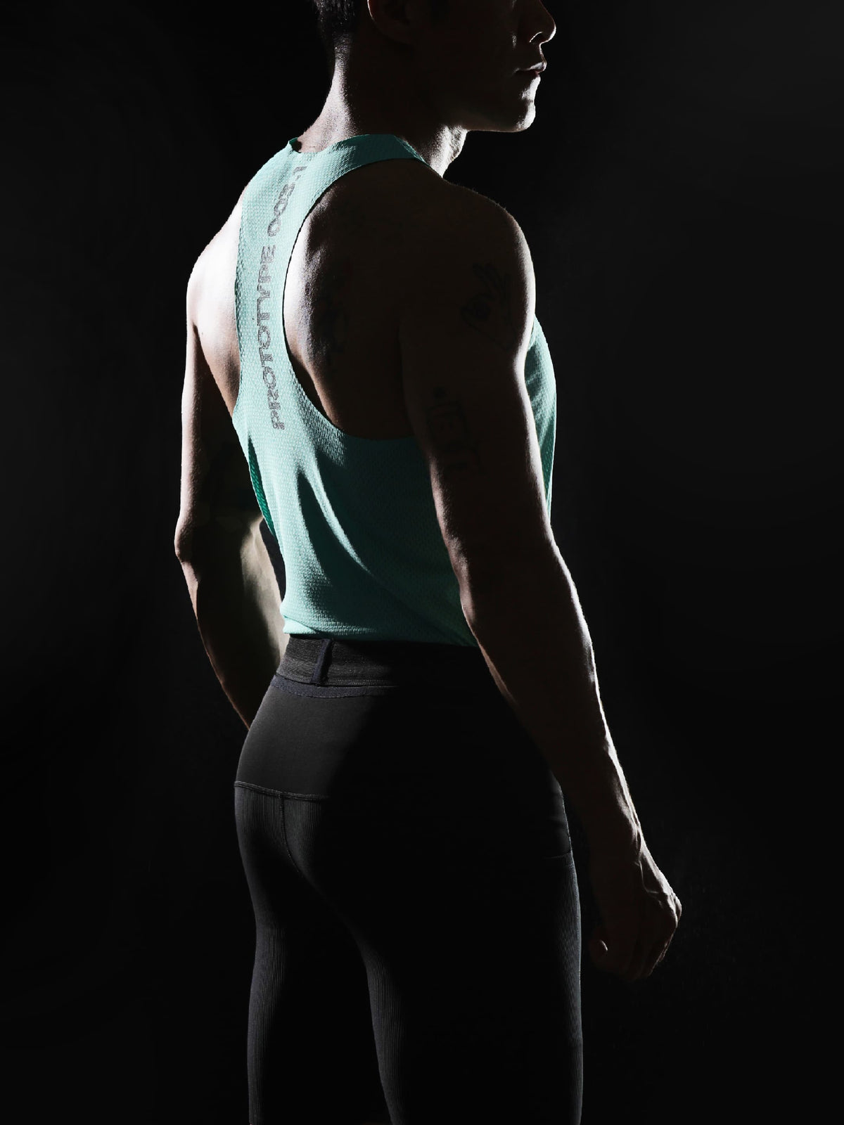 The elongated torso panel is designed to sit neatly inside the shorts, keeping the vest securely in place during movement.
